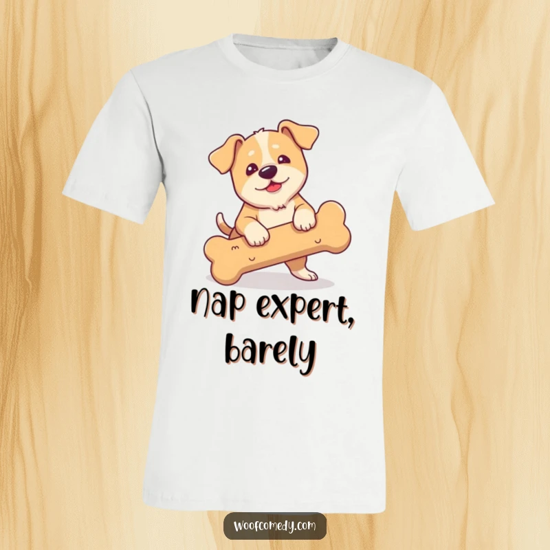 Funny t-shirt depicting a clumsy dog with droopy ears comically tripping over an oversized bone.